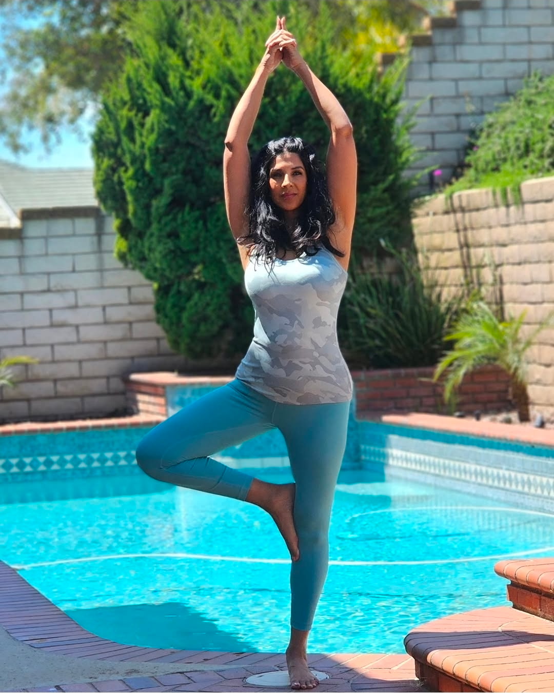 Jeena in tree pose by the pool at JeeNamaste Wellness Resort Spa