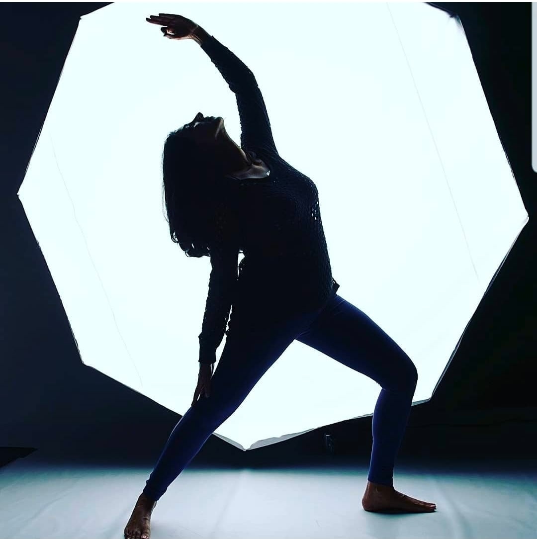Jeena in a dramatic silhouette yoga pose